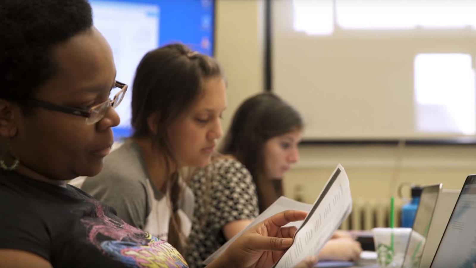 Students in class, reading quiz questions